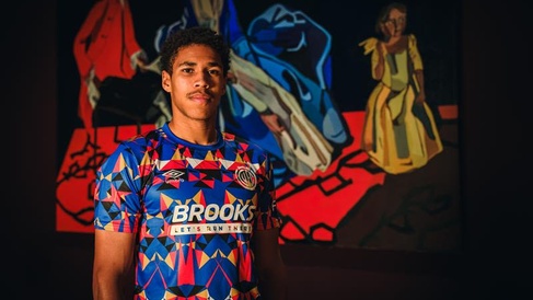 A young man wearing the Black History Month Cambridge United shirt