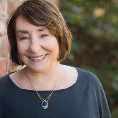 Photo of Jean Pfaelzer standing next to a brick wall
