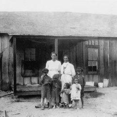 Early twentieth-century African American family standing outside a wooden home in Blackdom, New Mexico, one of the best-known Black towns founded after emancipation.