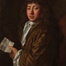 A painted portrait of Samuel Pepys with long, wavy hair wearing a brown robe and a white neck cloth. The person is shown from the waist up, standing against a dark background, holding a small sheet of paper in one hand. The brushwork highlights the folds of the clothing and the texture of the hair.