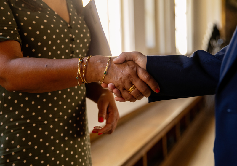 Two University staff members shaking hands